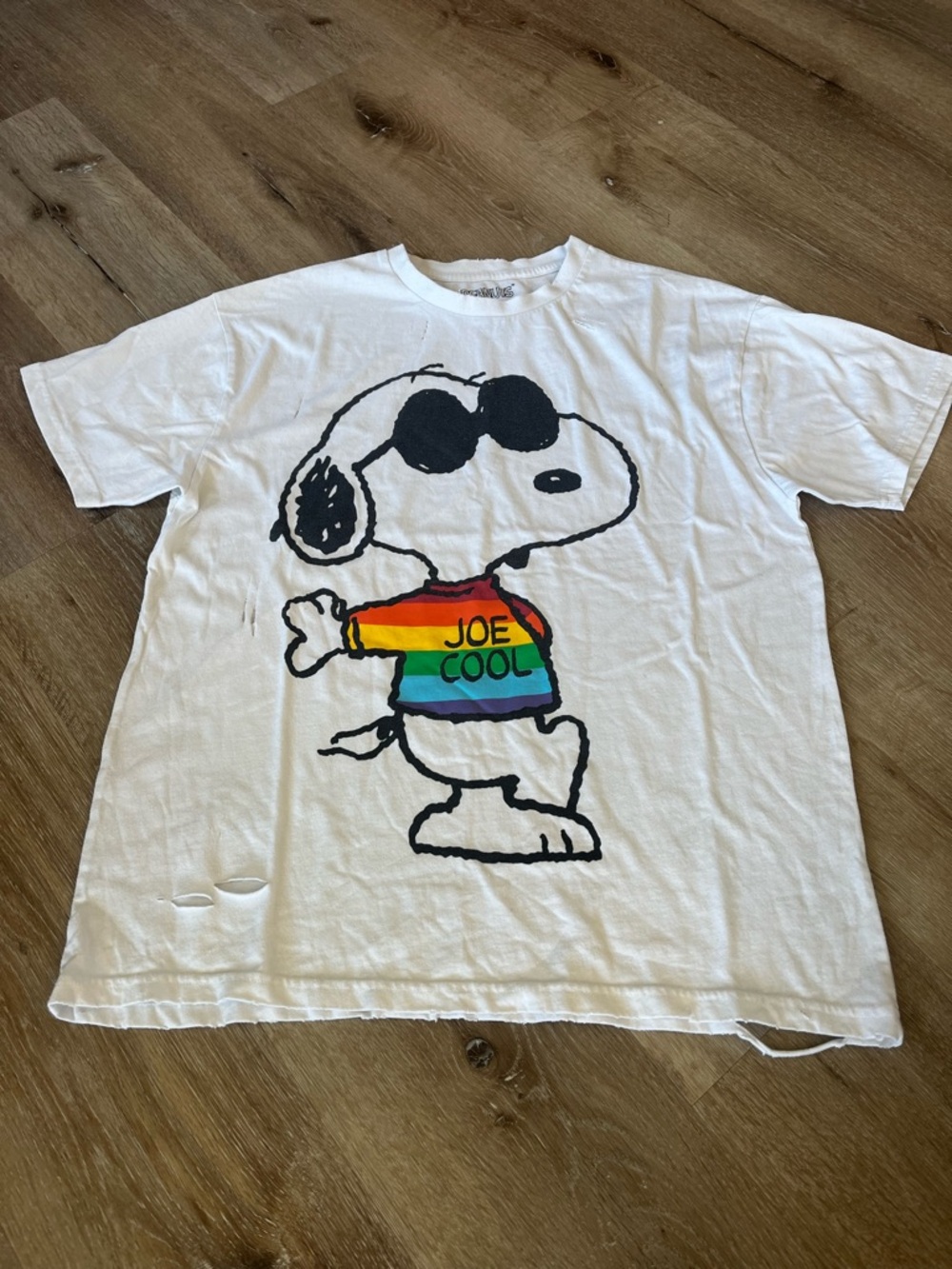 Peanuts White Graphic Distressed Tee with a Rainbow & Black Logo